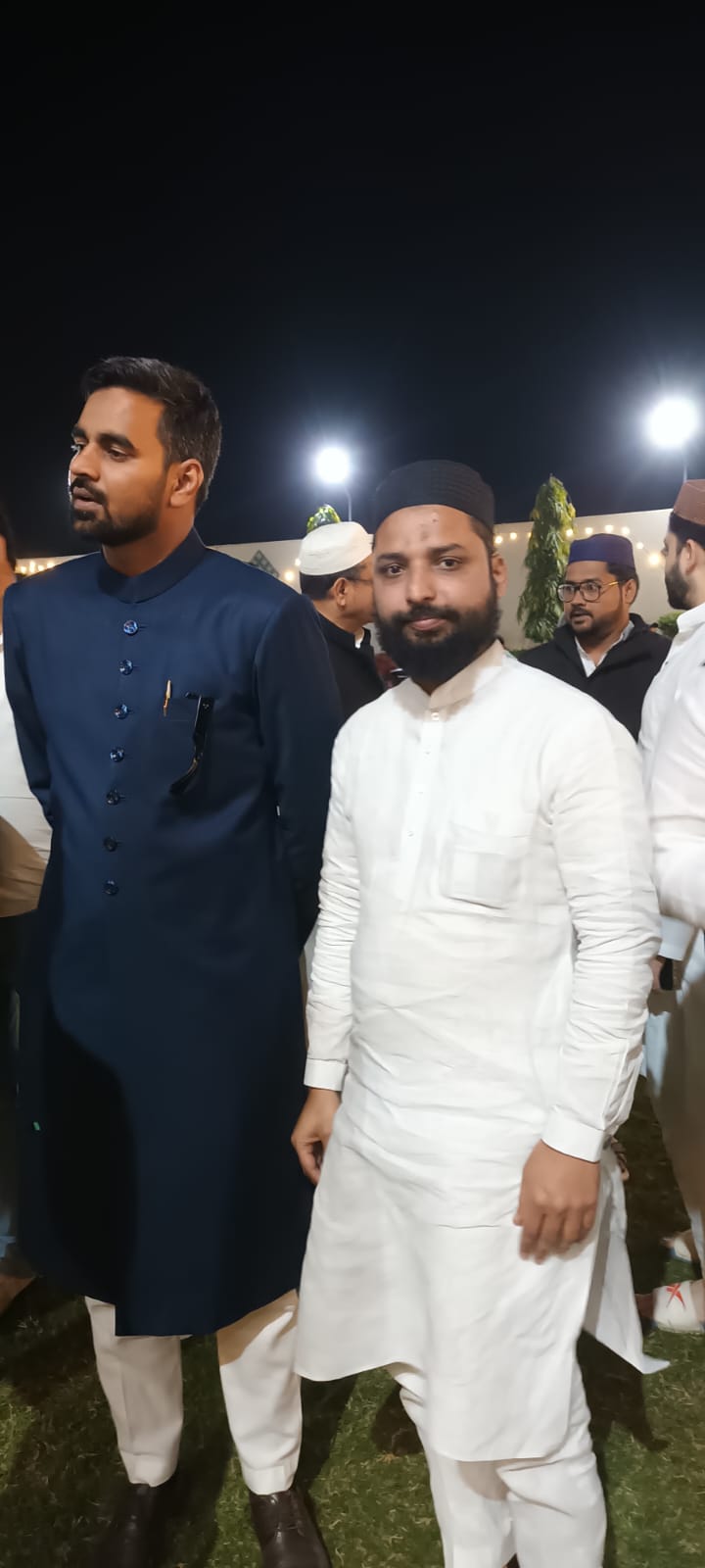 Wedding Celebration Gathering with Navy Blue Achkan and White Kurta